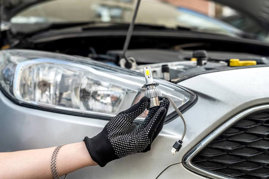 A driver takes care of a fix-it ticket by replacing an LED headlamp bulb.