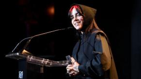 Billie Eilish smiles at an event celebrating successful women.