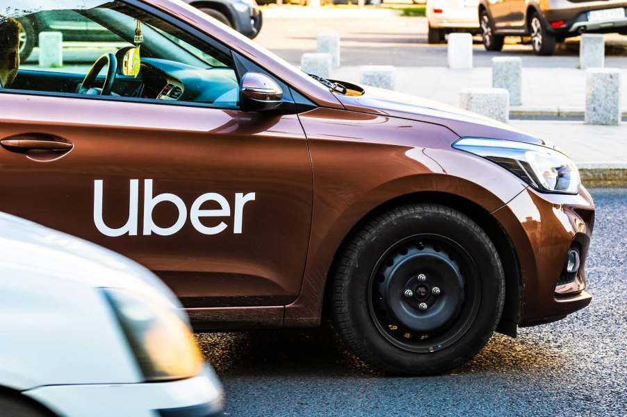 Uber badge on car door in traffic in Romania