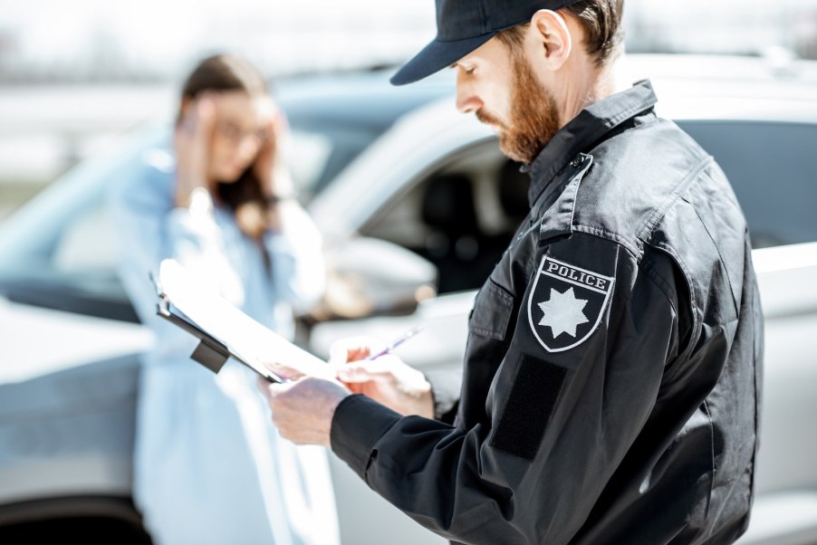 Police officer writes a ticket.