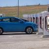 A row of Tesla Supercharger stalls and a Hyundai EV.