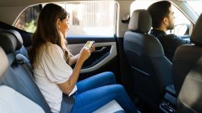 An Uber driver and passenger during a ride.