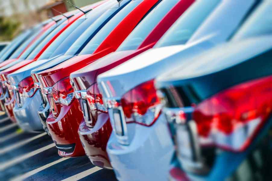 New car lot showing a row of cars photographed in close right rear angle