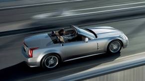 A Cadillac XLR drives with the top down.