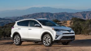 A white 2016 Toyota RAV4 SUV parked in right front angle view