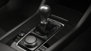 The stick shift lever in a manual Mazda3 hot hatchback wagon.