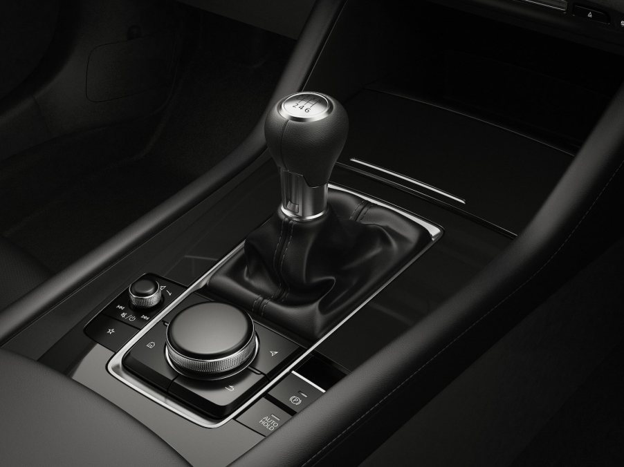 The stick shift lever in a manual Mazda3 hot hatchback wagon.