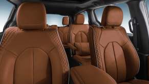 Tan leather seats inside a Chrysler Pacifica minivan.