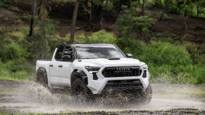 The 2024 Toyota Tacoma splashing through a puddle