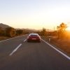 A 992 Porsche 911, one of the fastest cars on the modern market, heads down the road.