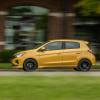 A Mitsubishi Mirage drives on the road.