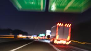 A blurred view of a semi-truck about to crash on a highway.