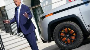 President Donald Trump speaks in front of the White House, next to a silver Lordstown Endurance electric EV pickup truck