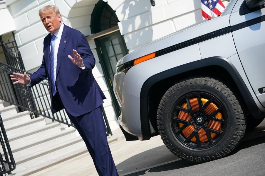 President Donald Trump speaks in front of the White House, next to a silver Lordstown Endurance electric EV pickup truck