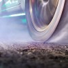 Closeup of a tire burning out during a drag race.