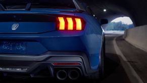 A Ford Mustang Dark Horse in a dark tunnel.