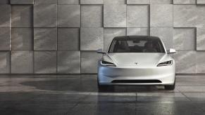 A white Tesla Model 3 shows off its front-end styling.