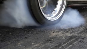 Smoking tire from high horsepower car spinning out.