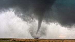 A tornado causes damage to farmland and rural communities.