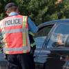 A police officer at a traffic stop during the daytime.