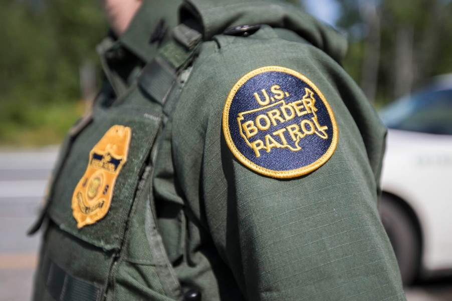 The U.S. Border Patrol patch on the arm of an agent during a highway checkpoint search.