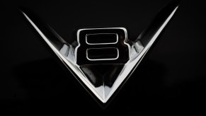 The chrome "V8" hood ornament from a car.