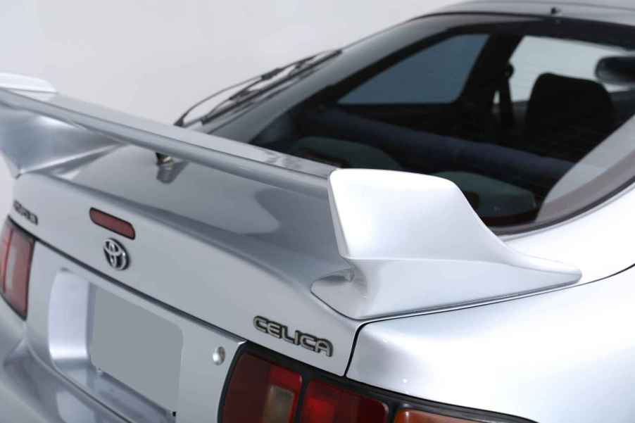 The rear spoiler and badges on a 1990s Toyota Celica