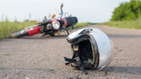 A helmet and motorcycle lying in the road