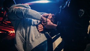 A man being arrested at night