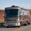 An RV on the road towing an SUV