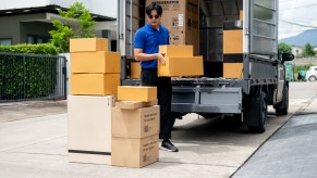 A man loading boxes into a moving truck