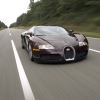 A Bugatti Veyron speeds down a road in central Europe.