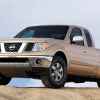 A gold 2005 Nissan Frontier pickup truck