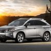 A silver 2014 Lexus RX 350 SUV parked in the desert at dusk in left front side angle