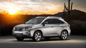 A silver 2014 Lexus RX 350 SUV parked in the desert at dusk in left front side angle