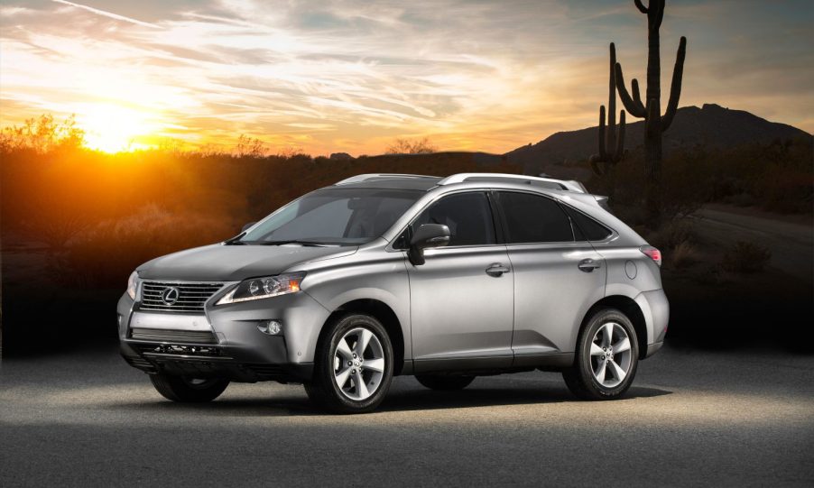 A silver 2014 Lexus RX 350 SUV parked in the desert at dusk in left front side angle