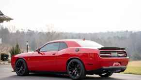 A red 2016 Dodge Challenger parked in left rear angle view