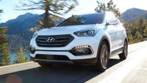 A white 2017 Hyundai Santa Fe driving