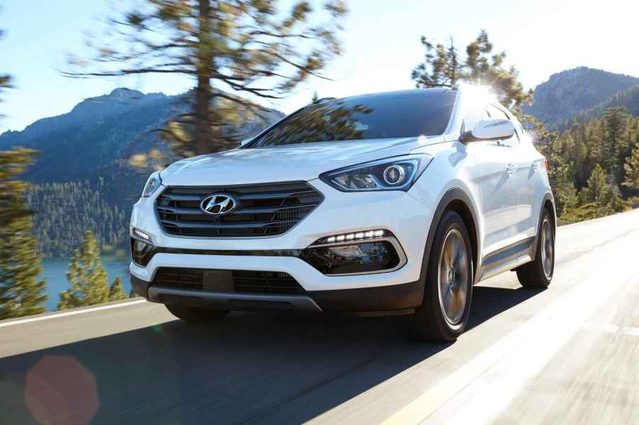 A white 2017 Hyundai Santa Fe driving