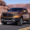 An orange-gold 2019 Ford Ranger driving in a rocky desert environment