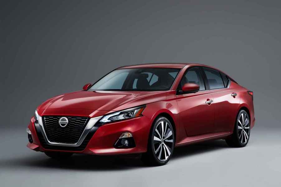 A red 2019 Nissan Altima parked in left front angle view on grey background and floor