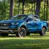 A blue 2020 Ford Ranger parked on grass in left front angle view