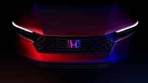 The front bumper of a 2023 Honda Accord in a darkened environment in very close view