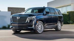 A 2024 Cadillac Escalade parked near a home