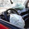 The interior of a crashed car with airbag deployed.