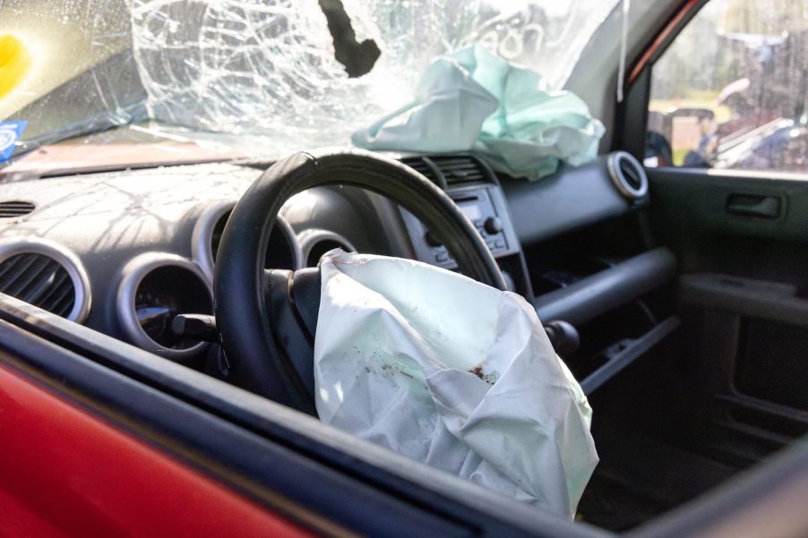 The interior of a crashed car with airbag deployed.