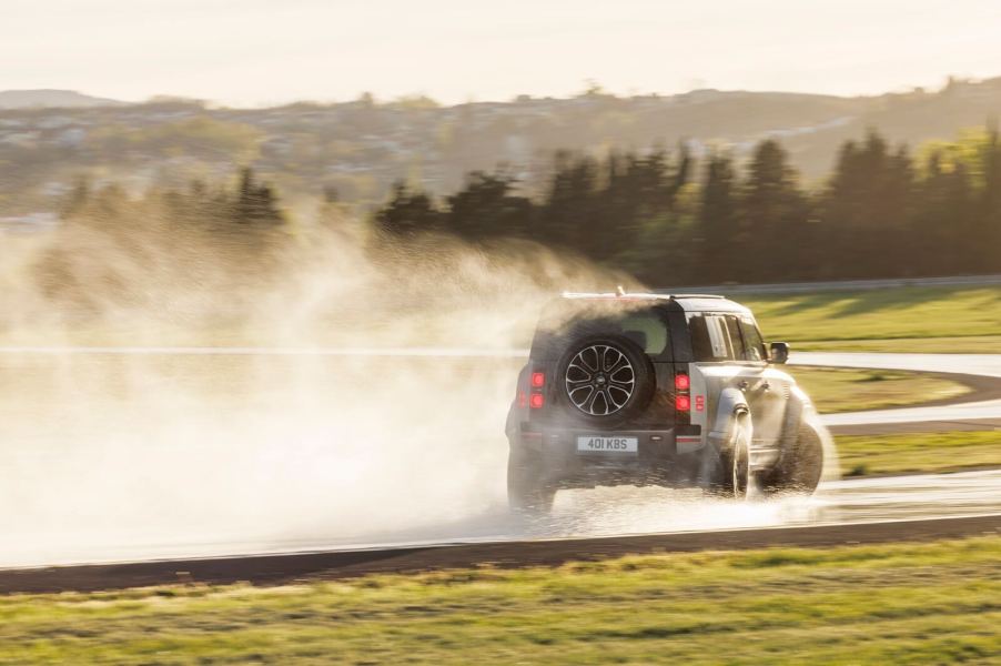 A Land Rover Defender 110 kicks up dirt without crashing.