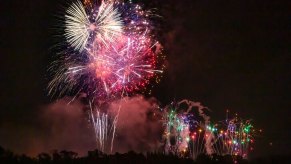 People fire off a volley of fireworks during a warm Florida night.