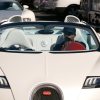 Boxer Floyd Mayweather jr. drives a white Bugatti Veyron through the street of Las Vegas.