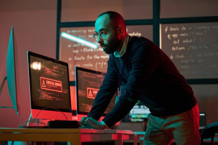 IT expert troubleshooting an internet outage in an office.